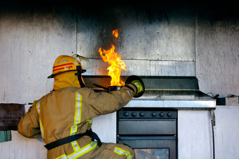 Fireman putting out a kitchen fire | MakeItGrateful.com