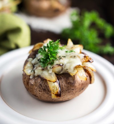 These sweet and savory Caramelized Onion and Spinach Stuffed Mushrooms topped with melted cheese are the perfect rich and flavorful Thanksgiving starter | MakeItGrateful.com