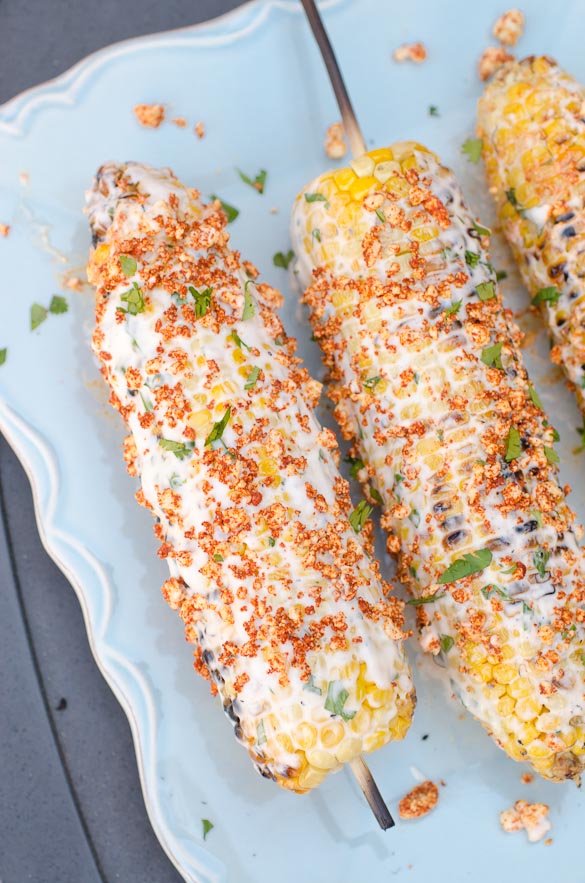 corn on the cob topped with cilantro, lime, paprika and cotija cheese