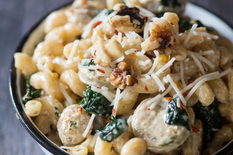 Creamy pasta with chicken sausage, spinach and walnuts