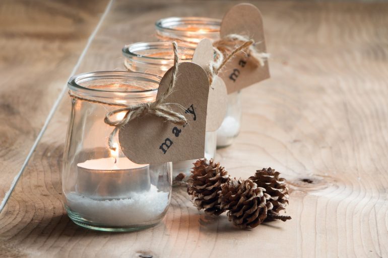 Hand-stamped place cards on candle jars