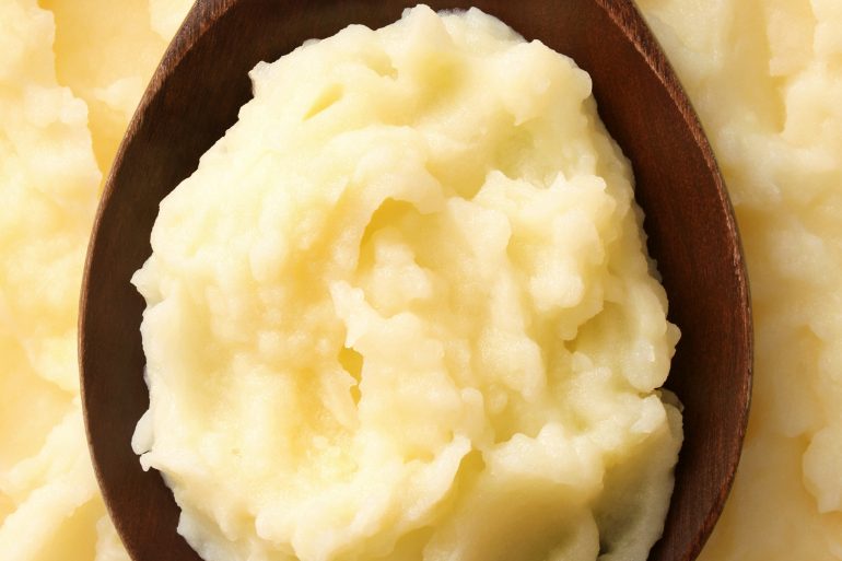 Mashed potatoes on a wooden spoon