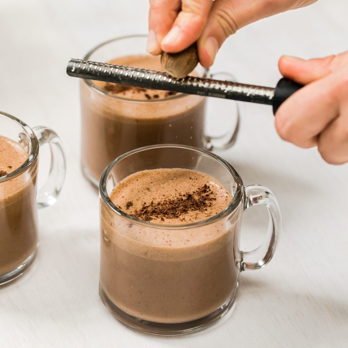 Shaving chocolate on a finished cup of rich mocha eggnog