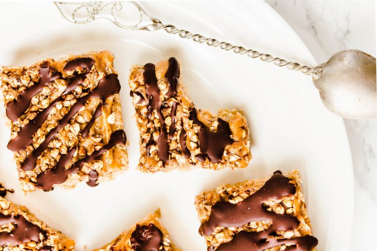 chocolate oat bars with spoon on white plate