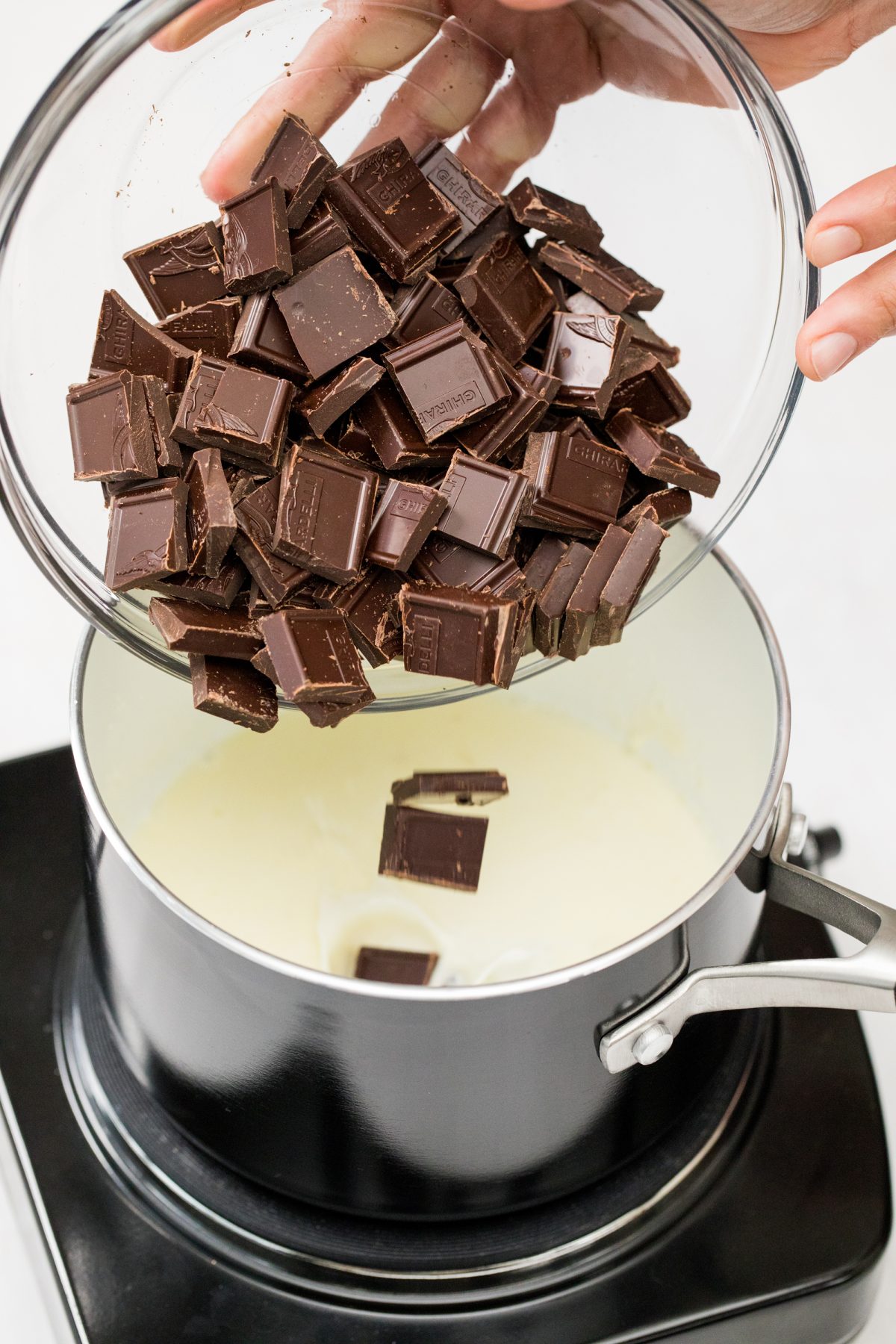 Adding chocolate bar chunks to the pot
