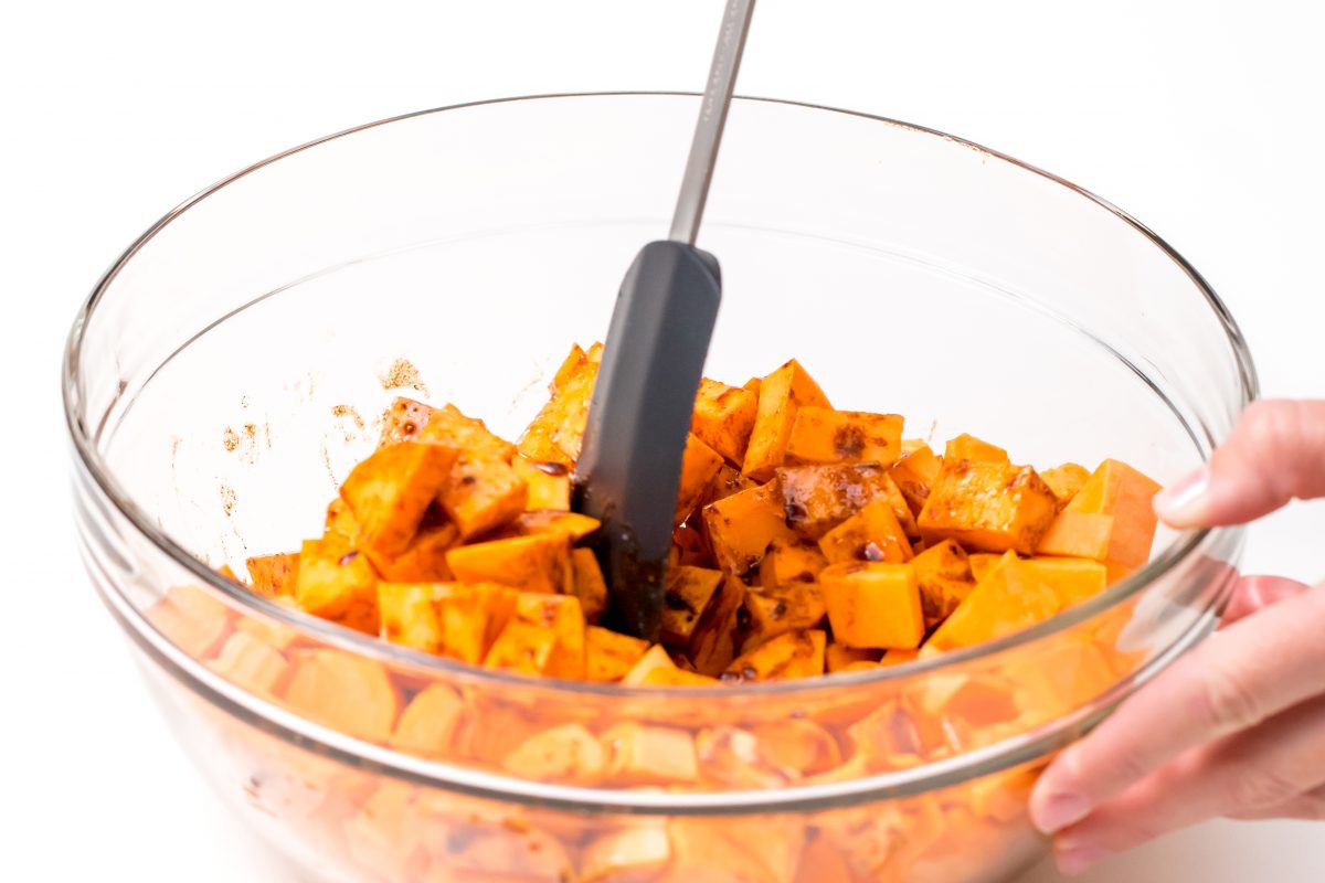 Toss sweet potatoes with sauce mixture for Roasted maple cinnamon sweet potatoes
