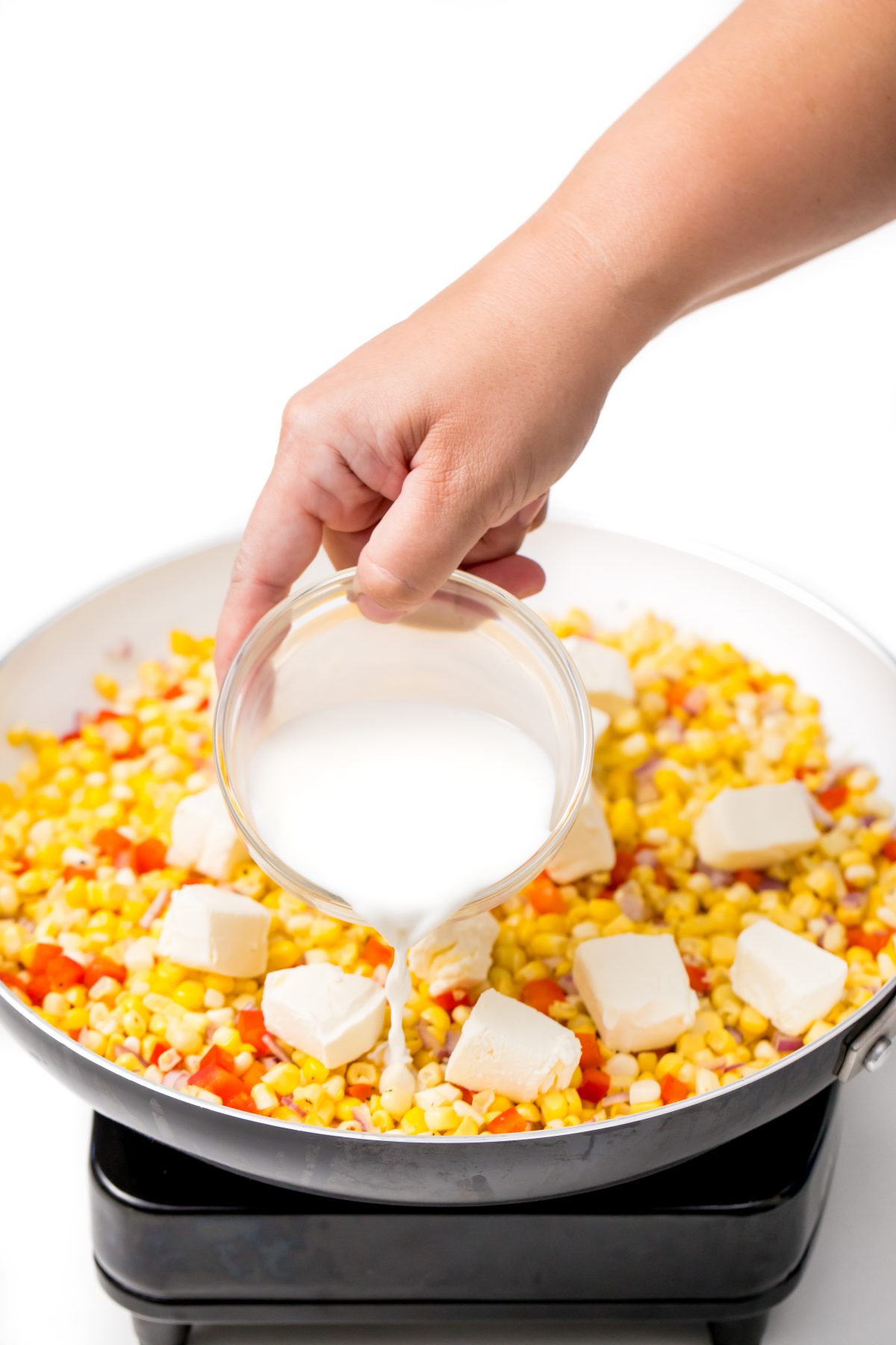 Stir cream cheese and then milk into corn mixture