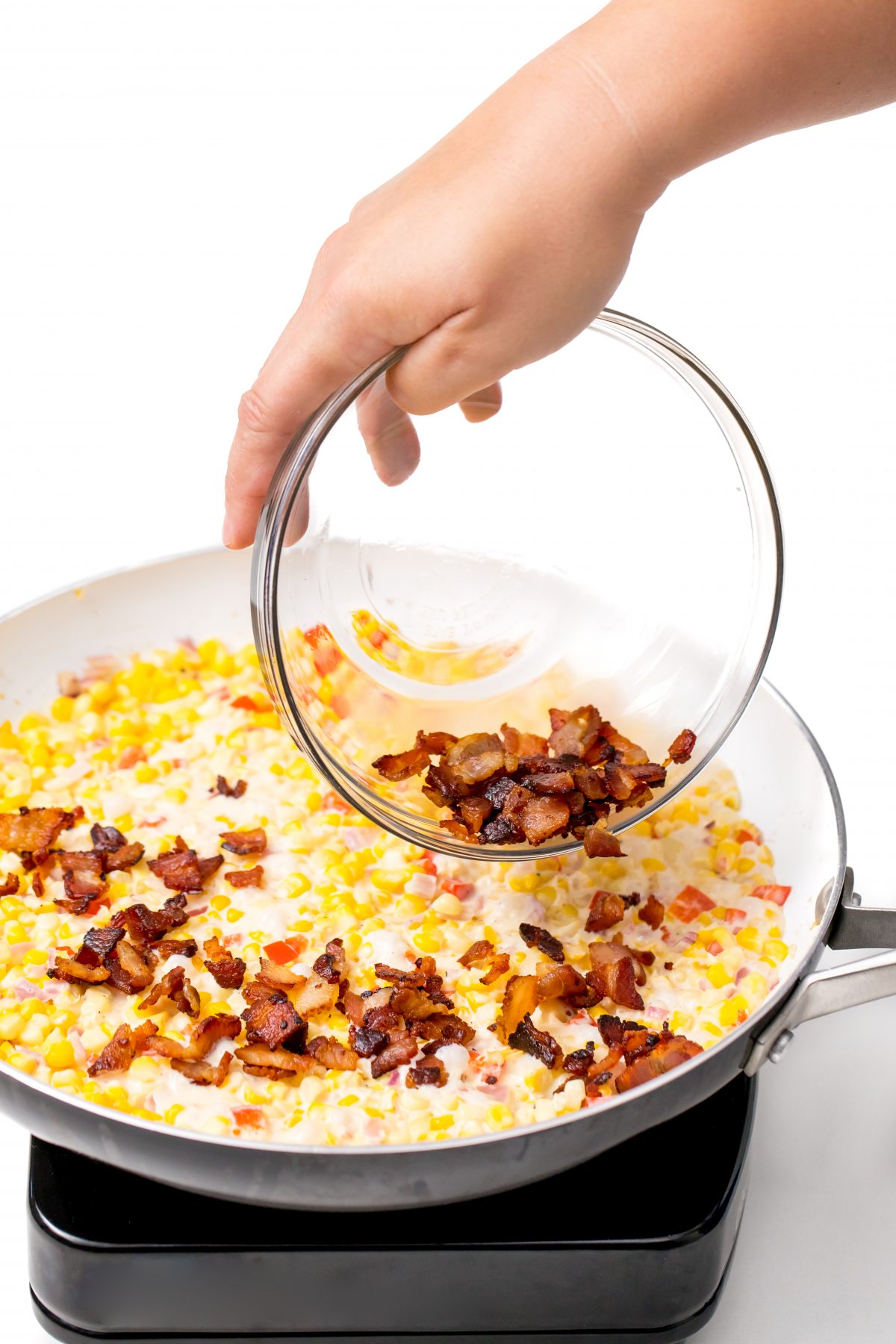 Reincorporate bacon crumbles into corn mixture