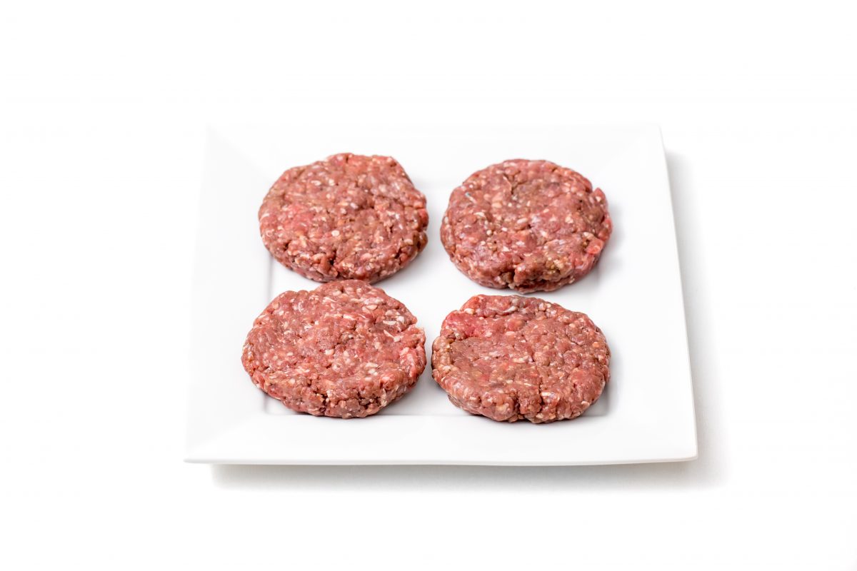 Oven baked burgers raw burger patties on square plate