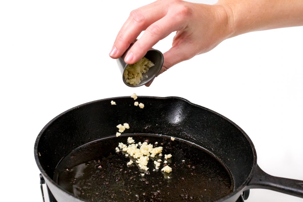 Add garlic to pan for Creamy salmon piccata