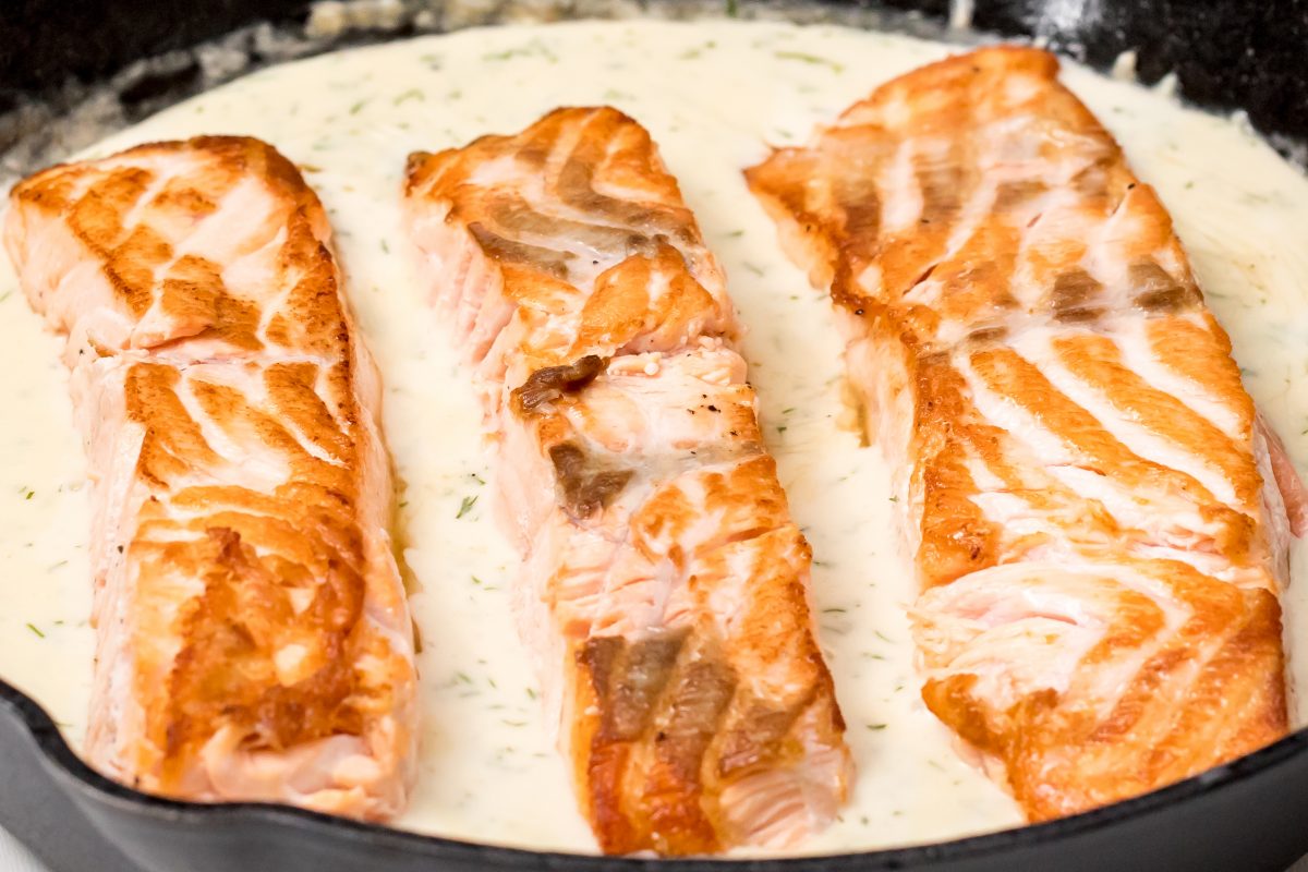 Add salmon back into creamy piccata sauce