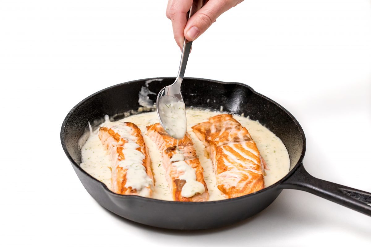 Spoon sauce over the top of salmon