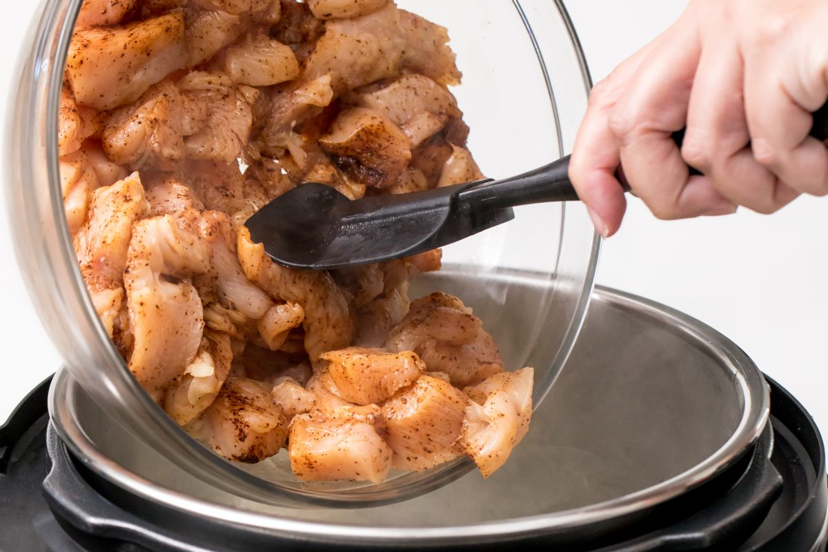 Put marinated chicken into the pressure cooker
