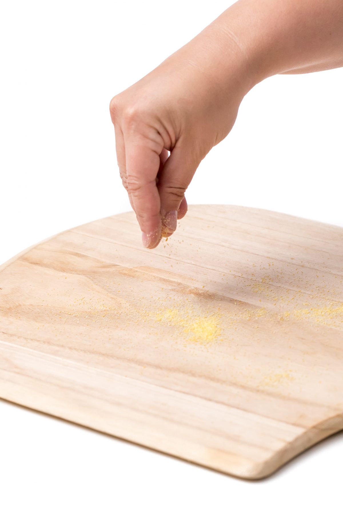 Sprinkle cornmeal on pizza peel to prevent sticking