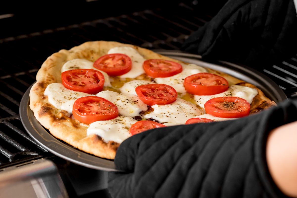 Place pizza back on grill and cook until mozzarella melts