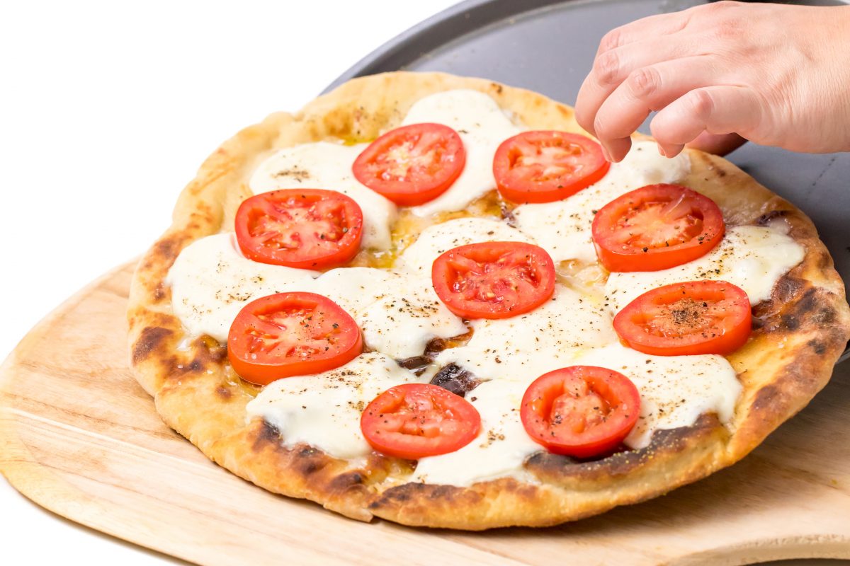 Transfer cooked pizza back to peel