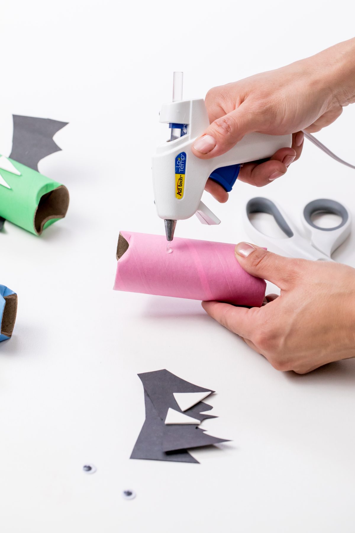 Use glue gun to adhere glue to paper tube