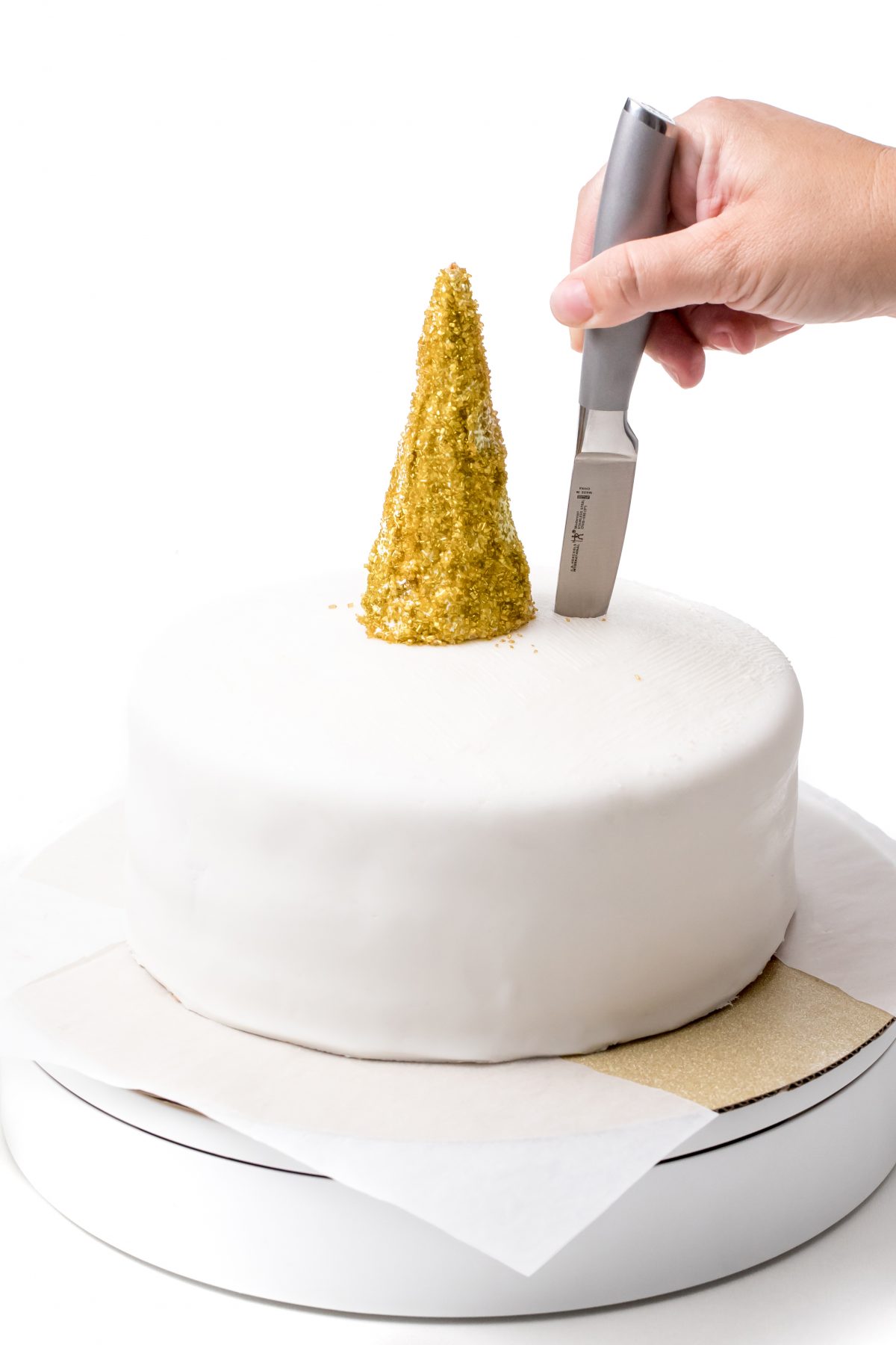 Place horn on cake and cut slits for ears