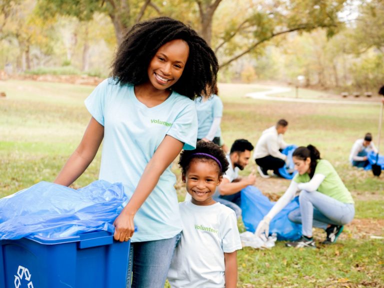 Young girl and her mom help clean up community