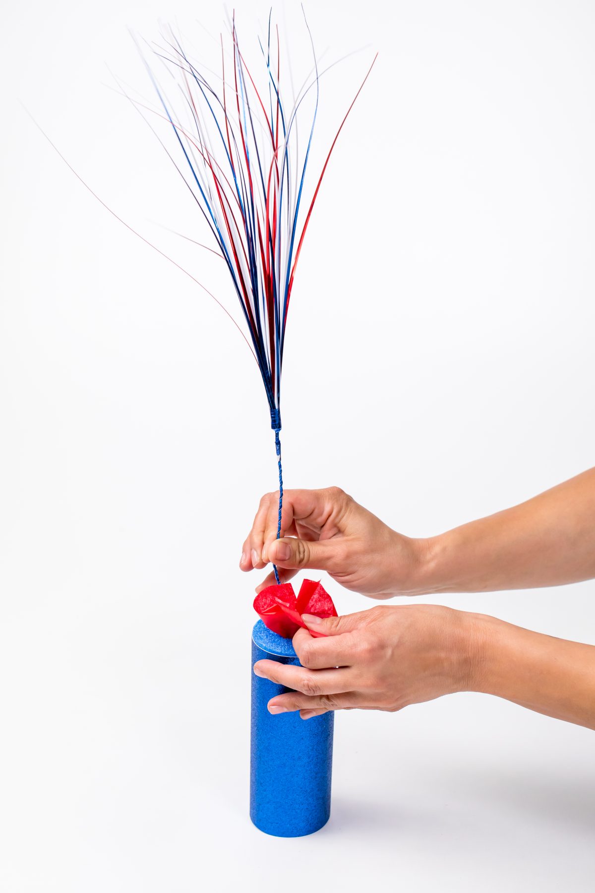 Stuff pool noodle with red white and blue streamer