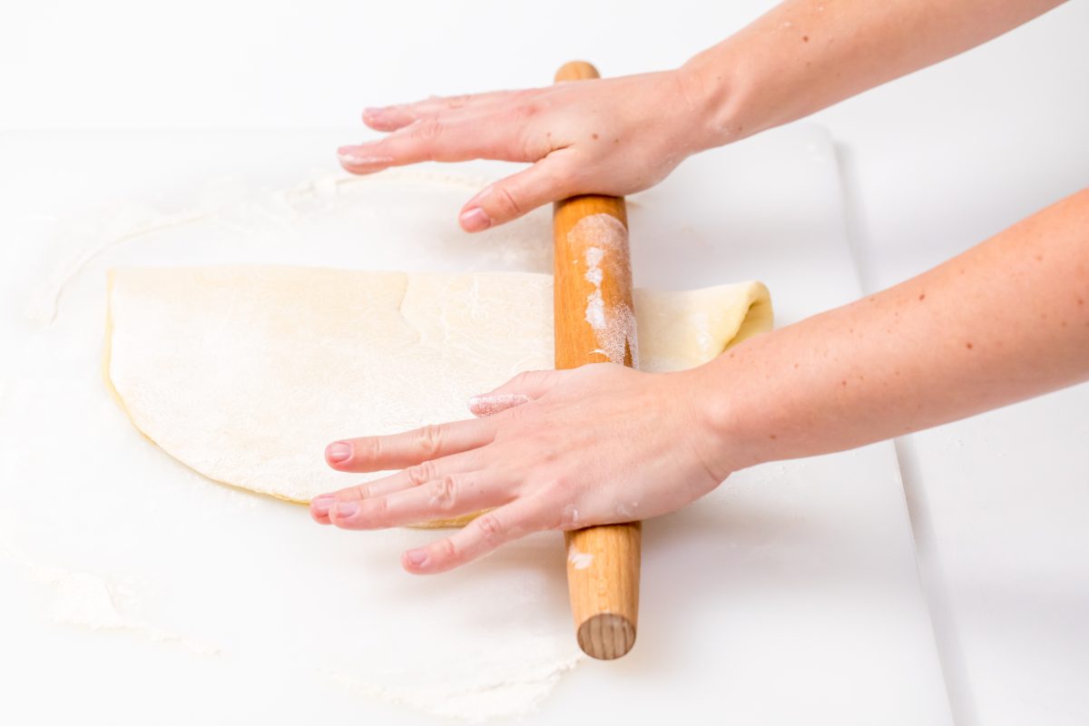 roll dough in half with rolling pin