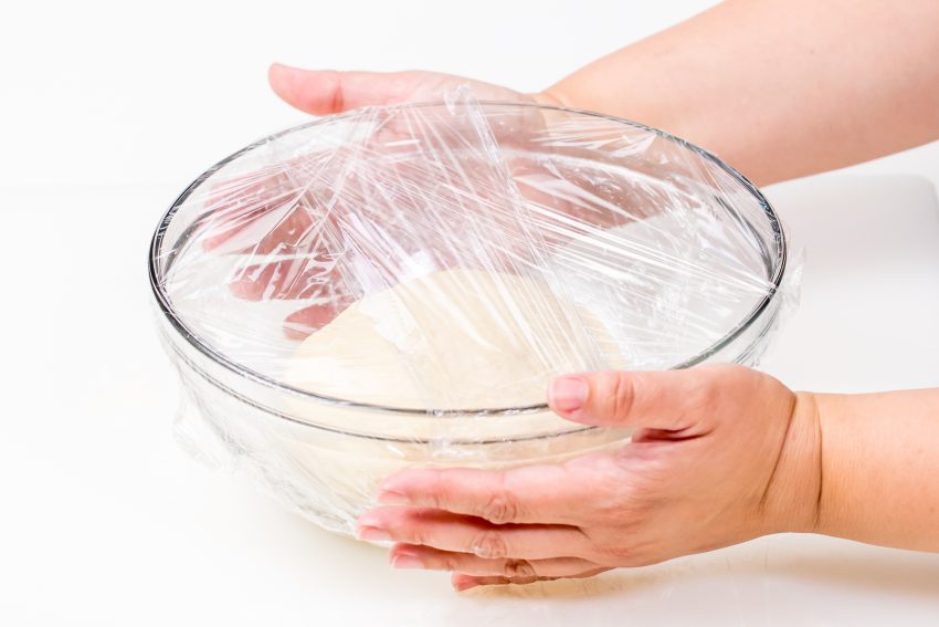 5D4B5397 - Easy Pretzel Rolls - wrapping dough with plastic wrap in a mixing bowl