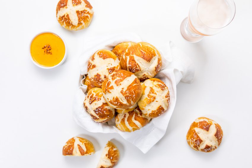 5D4B5901 - Easy Pretzel Rolls - a bread basket filled with preztel rolls surrounded by cheese and beer