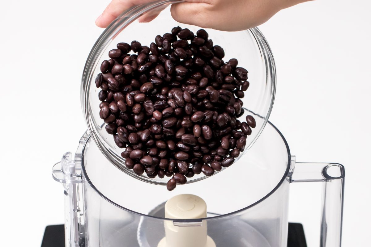 Pour black beans into food processor