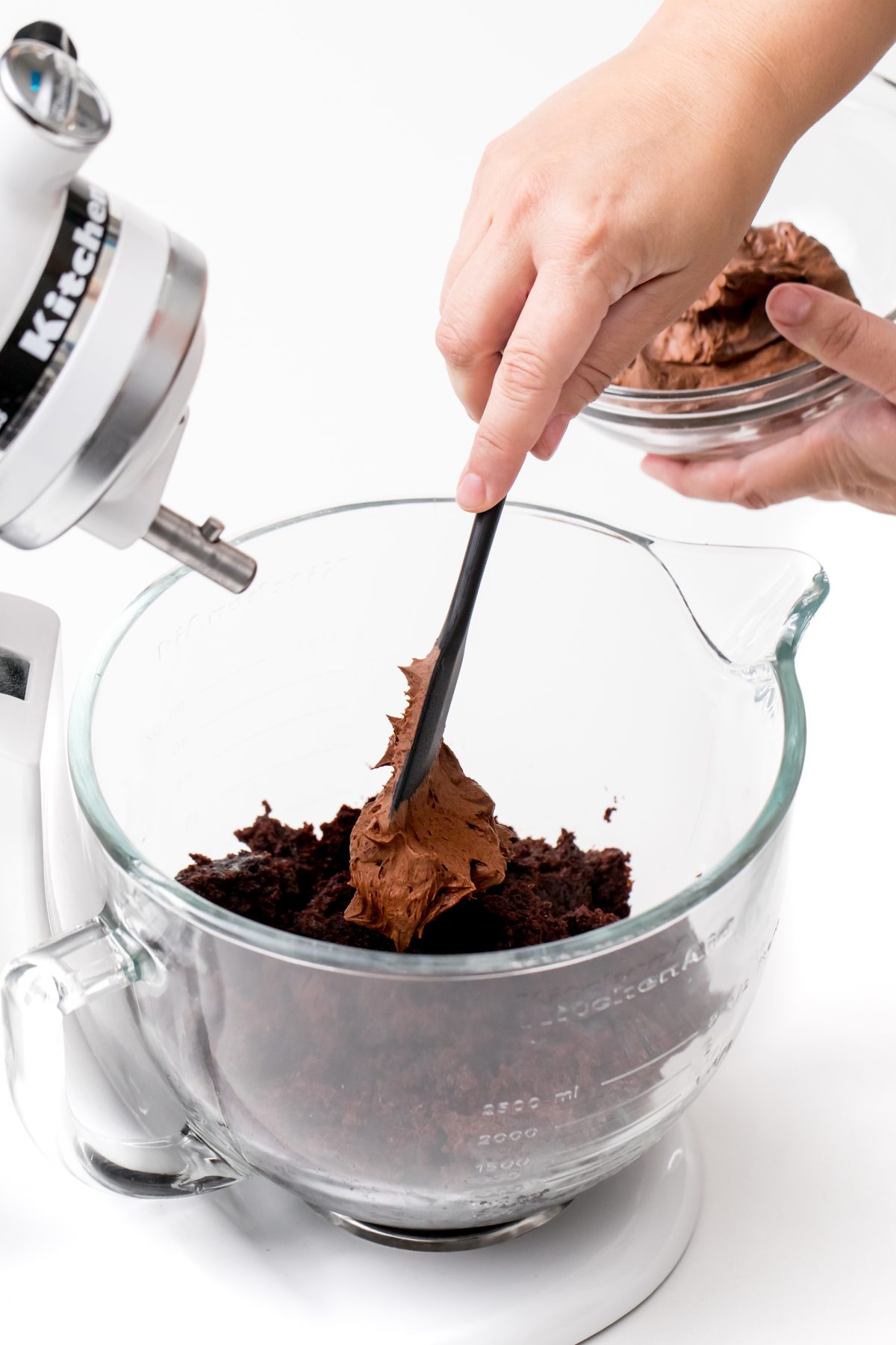 Add in chocolate buttercream frosting gradually and blend until it forms a dough