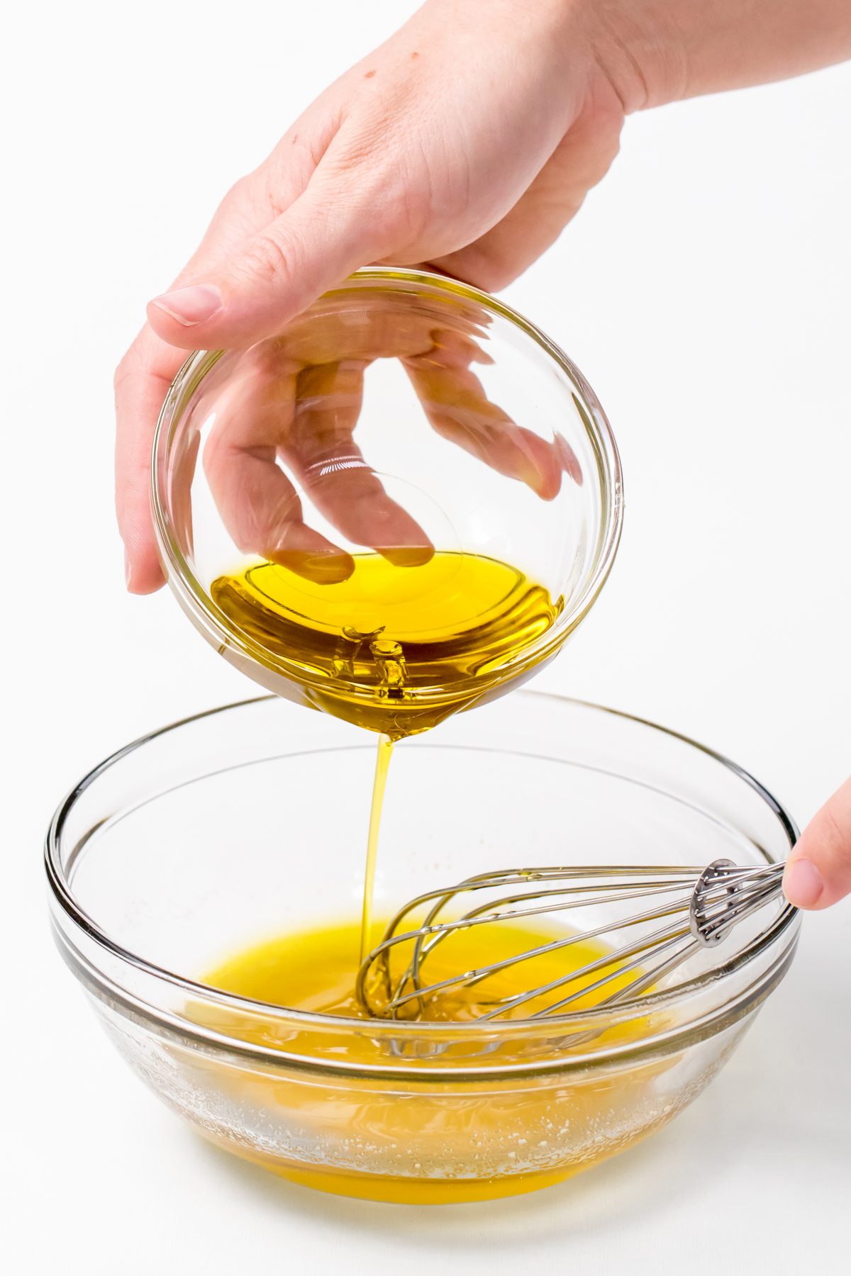 Adding extra virgin olive oil to dressing