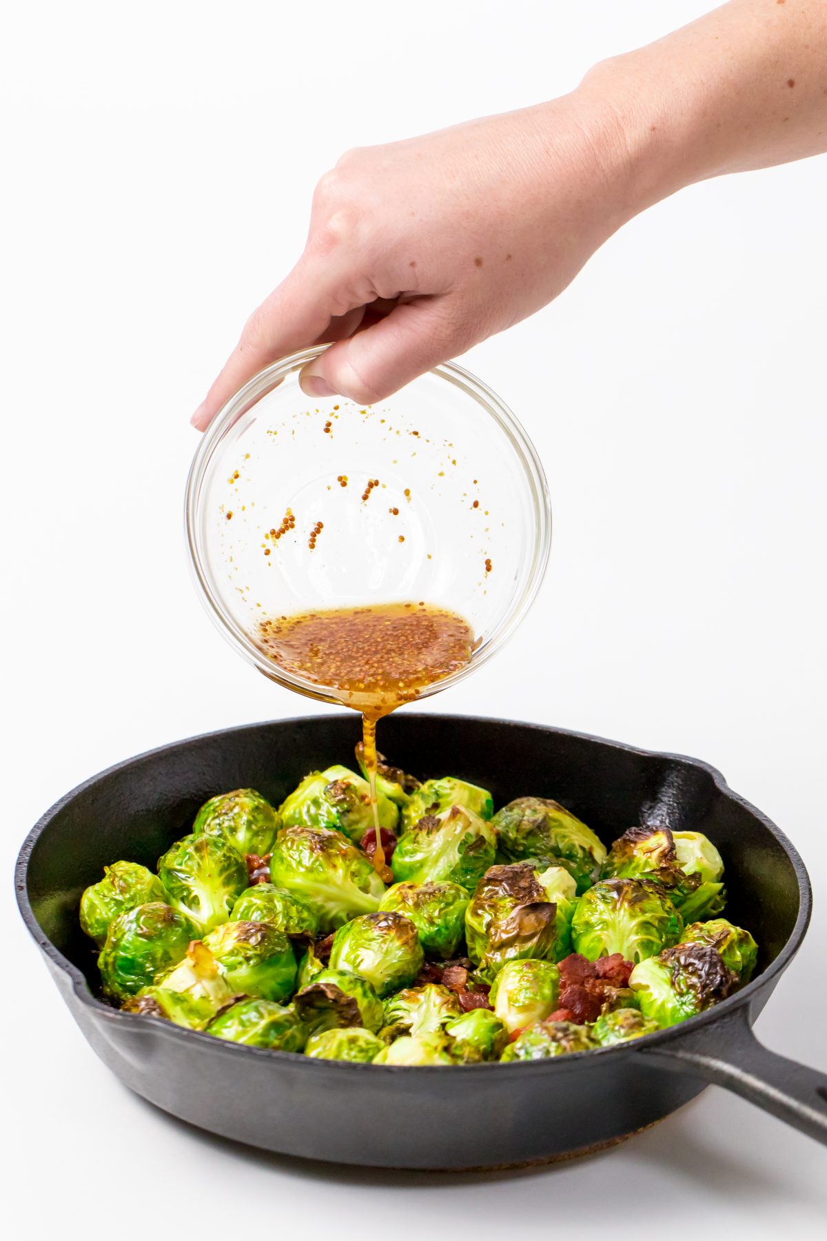 Pour maple syrup mixture over bacon and brussels sprouts