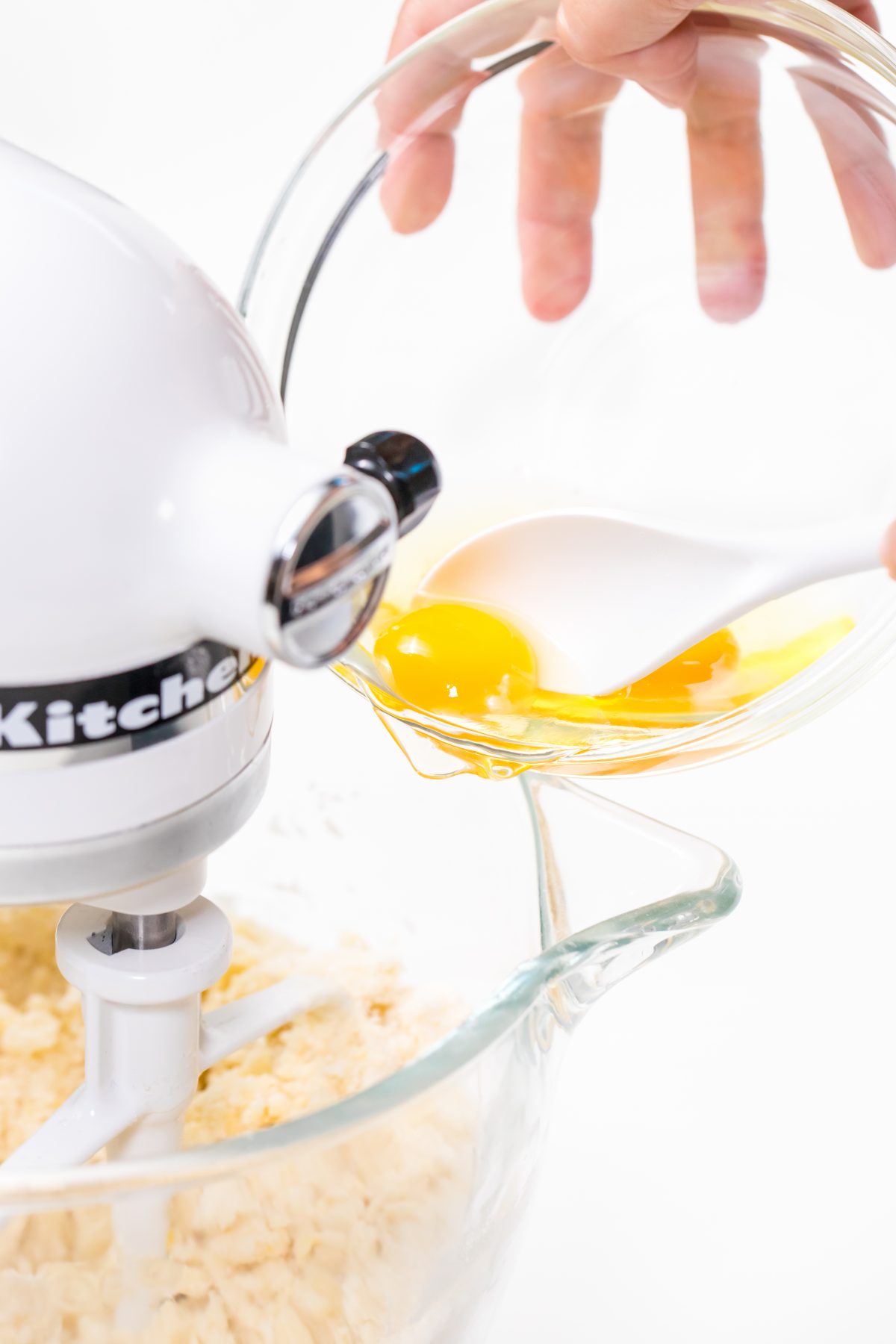Pour whole eggs into mixing bowl