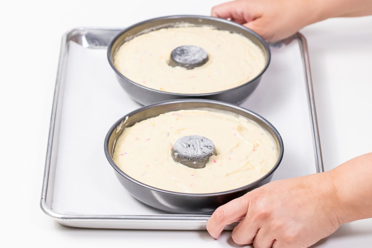 Fill pans with cake batter and place on baking sheet