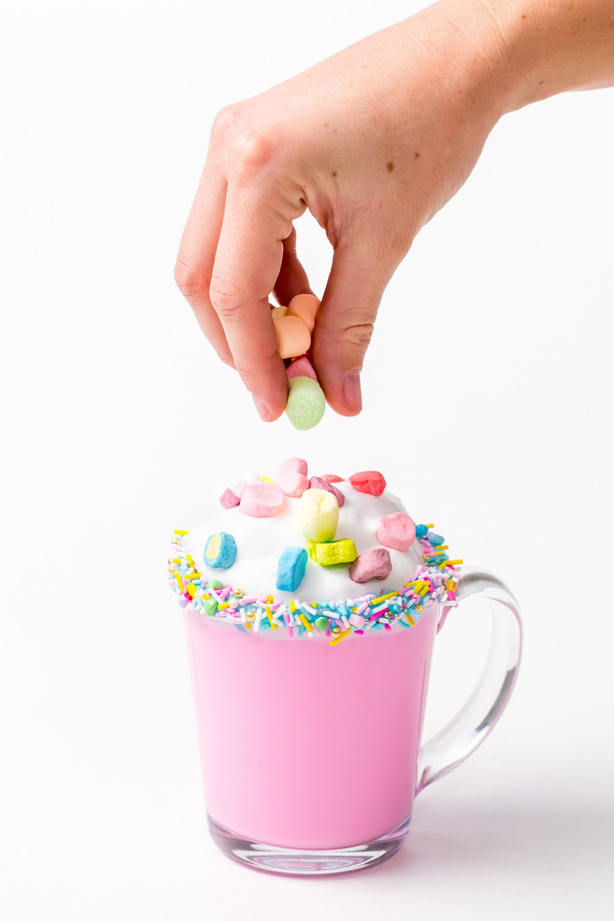 5D4B3079 - Unicorn Hot Chocolate - adding lucky charms marshmellows over the whipping cream