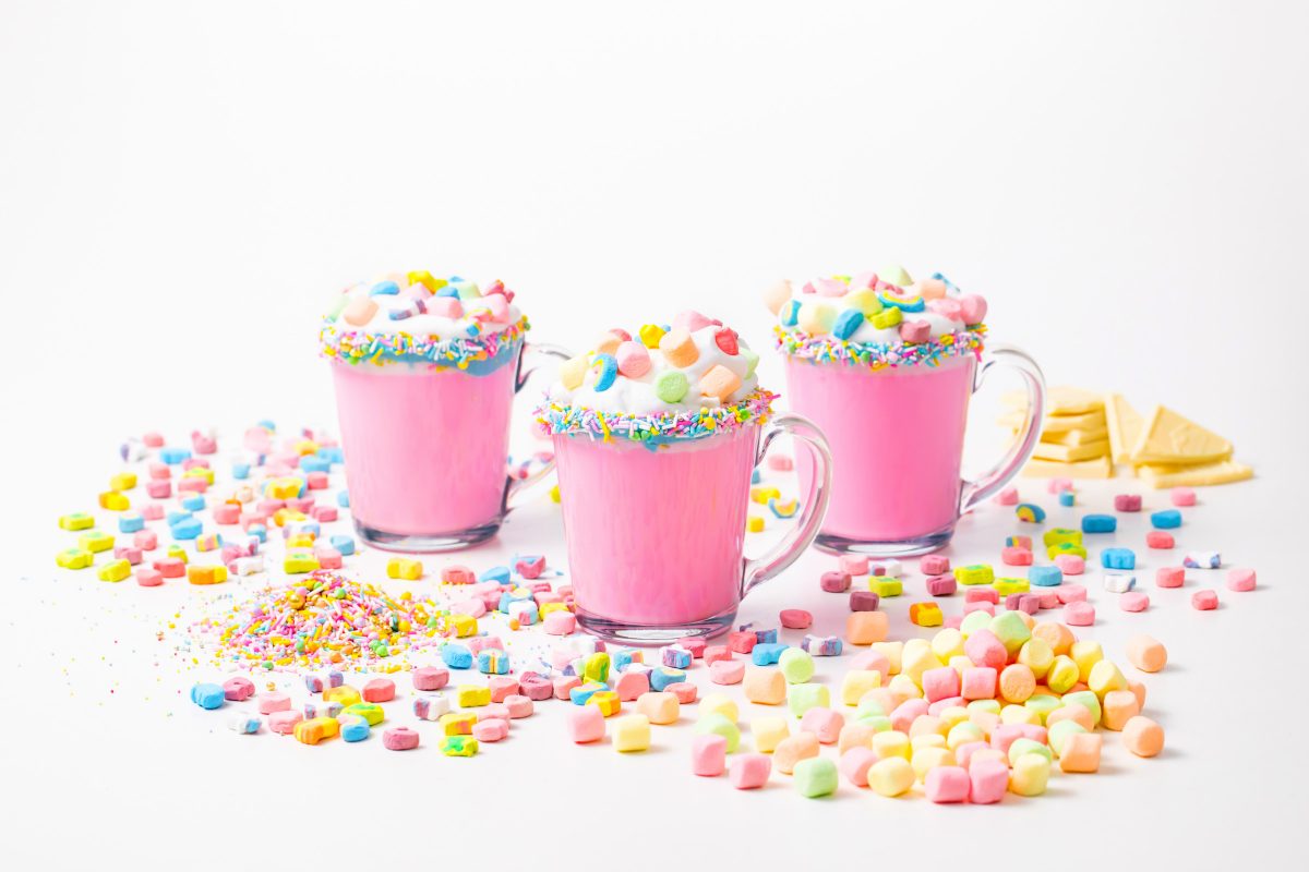 5D4B3094 - Unicorn Hot Chocolate - pink hot chocolate with whipping cream, lucky charms marshmellows on a white table
