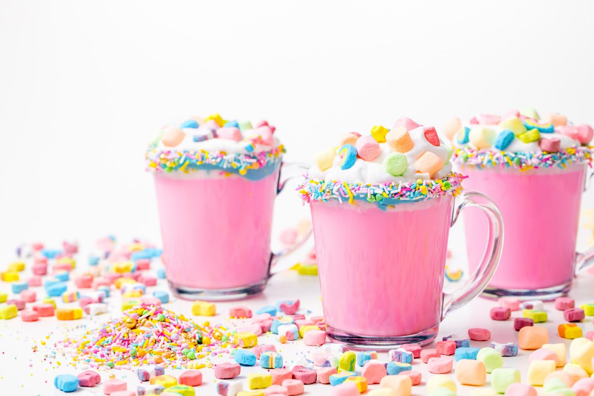 5D4B3103 - Unicorn Hot Chocolate - pink hot chocolate with whipping cream, lucky charms marshmellows on a white table