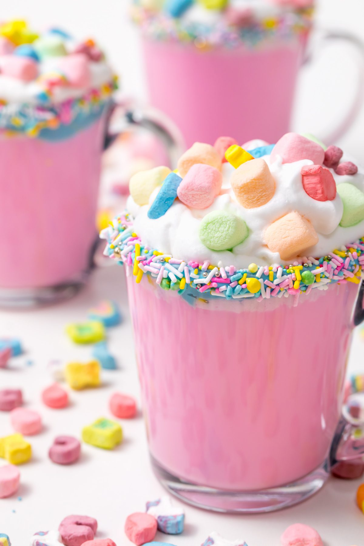 5D4B3149 - Unicorn Hot Chocolate - pink hot chocolate with whipping cream, lucky charms marshmellows on a white table