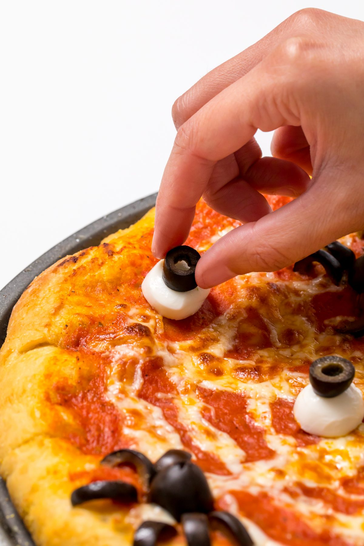 Create eyeballs using mozzarella balls and olives