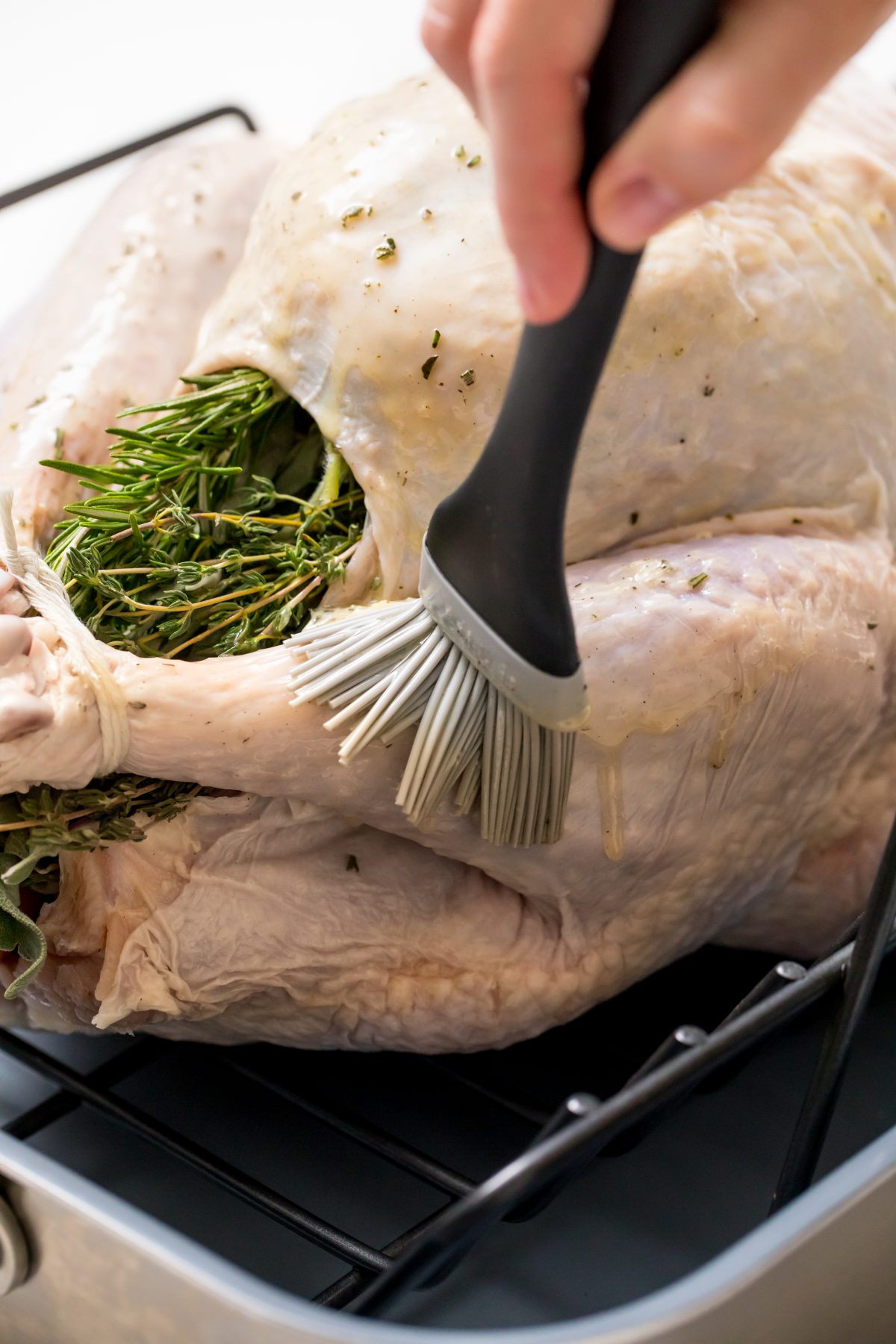 5D4B5034 - Easy No fuss Thanksgiving Turkey - brushing remaining herb butter onto turkey