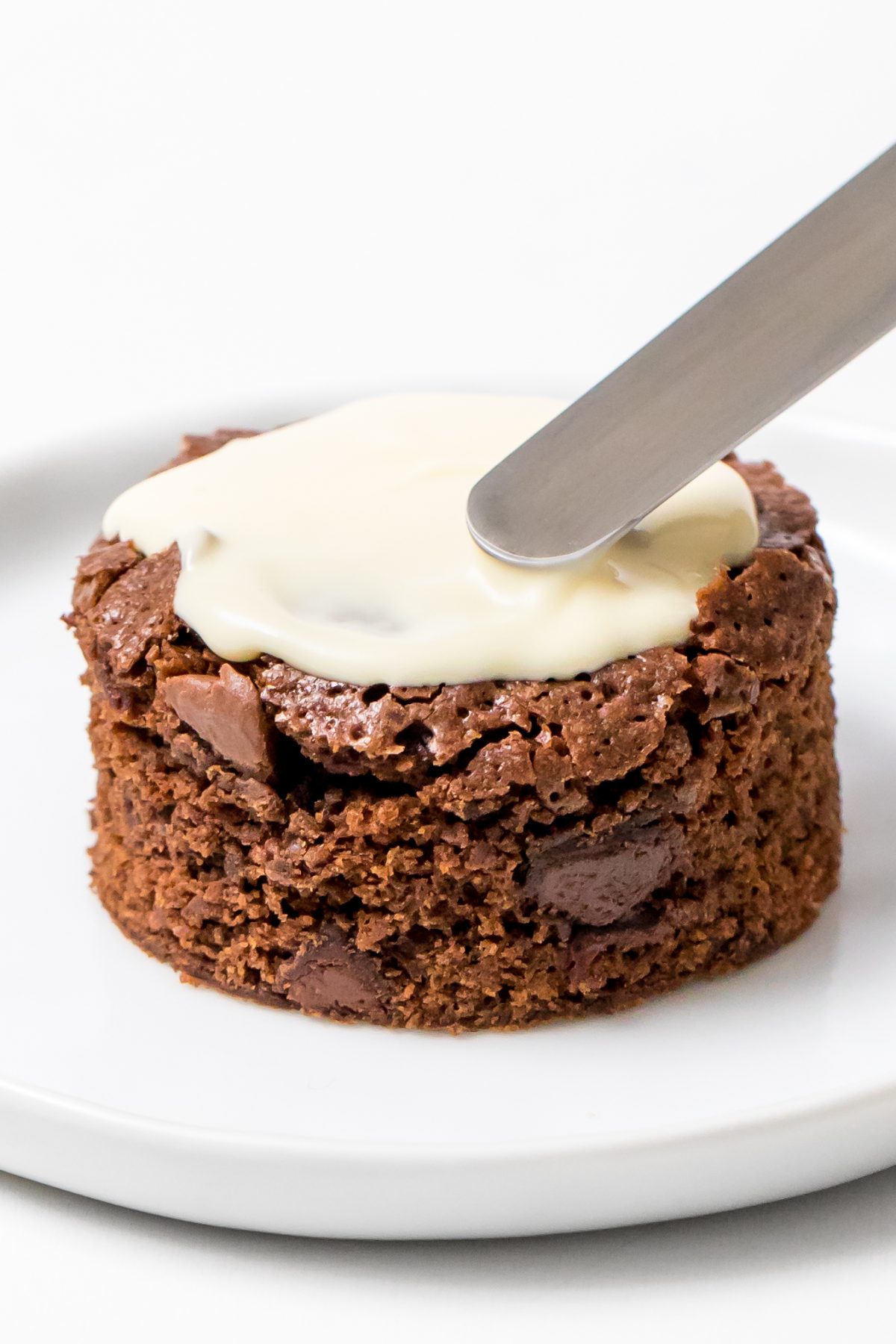 Frost brownies with melted white chocolate