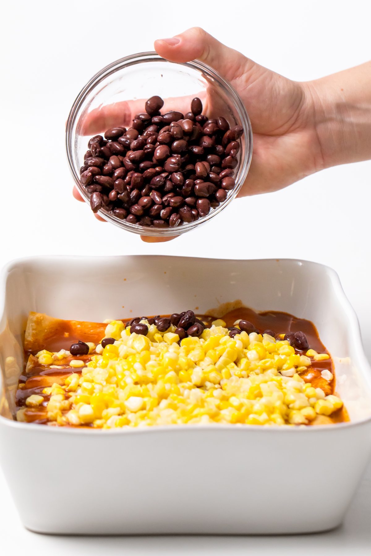Load up the enchiladas with corn, black beans, and cheese