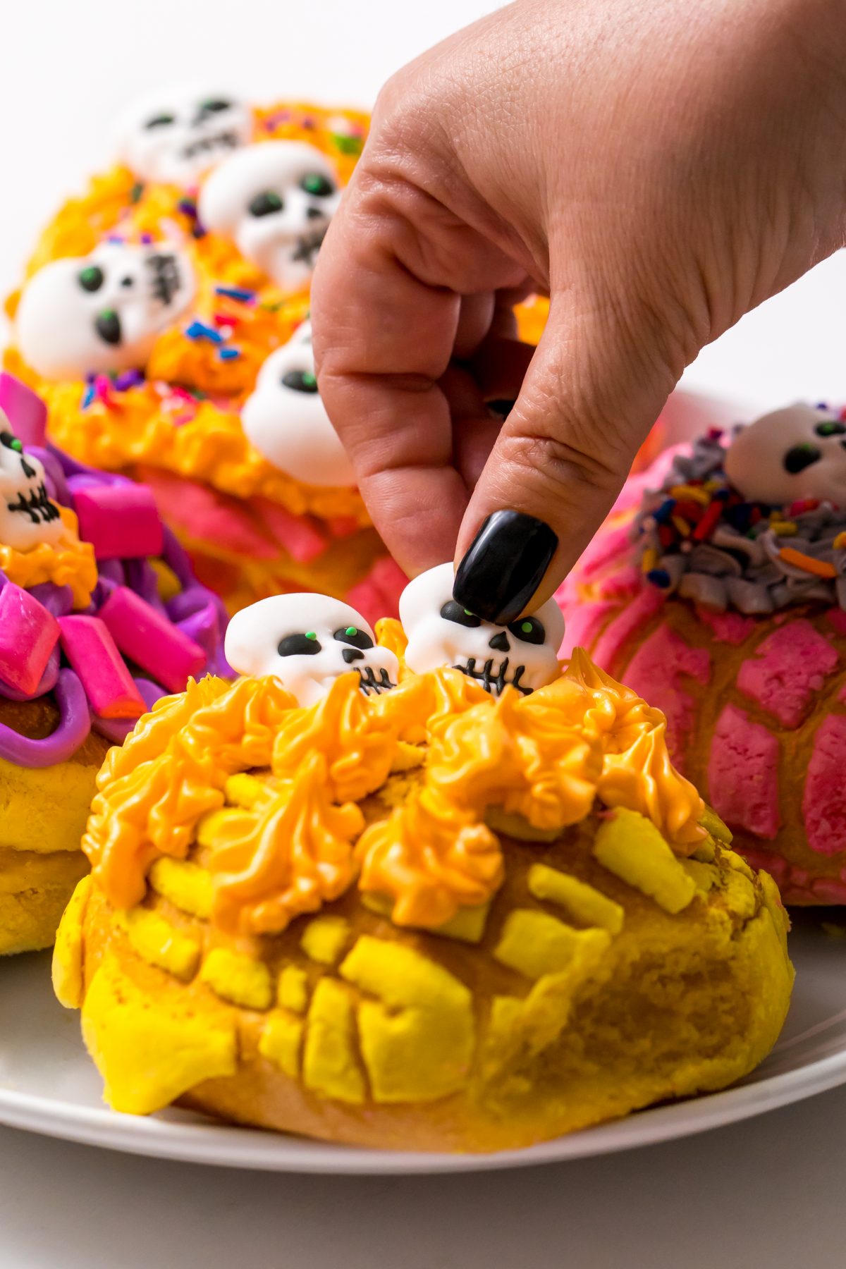 5D4B6518 - Crafty Chica - Day of the Dead Conchas - placing candy skull onto frosted concha