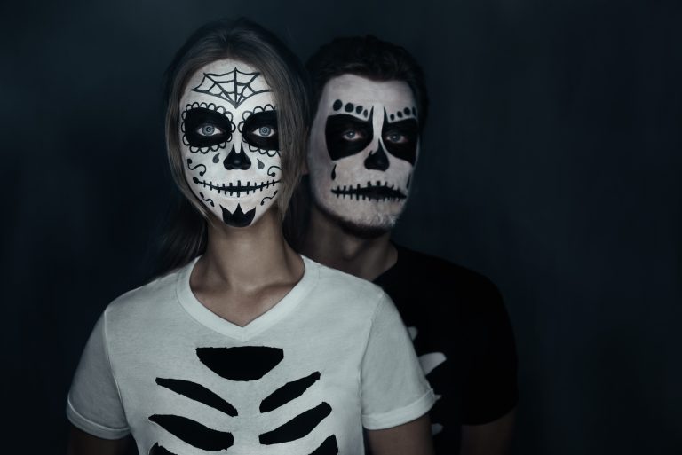 Couple in costumes of skeletons