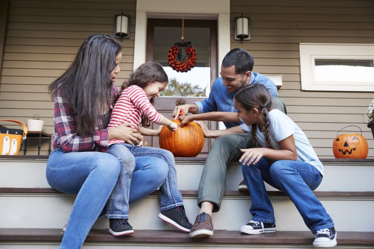 Halloween Pumpkin Designs Family Carving Halloween Pumpkin On House Steps