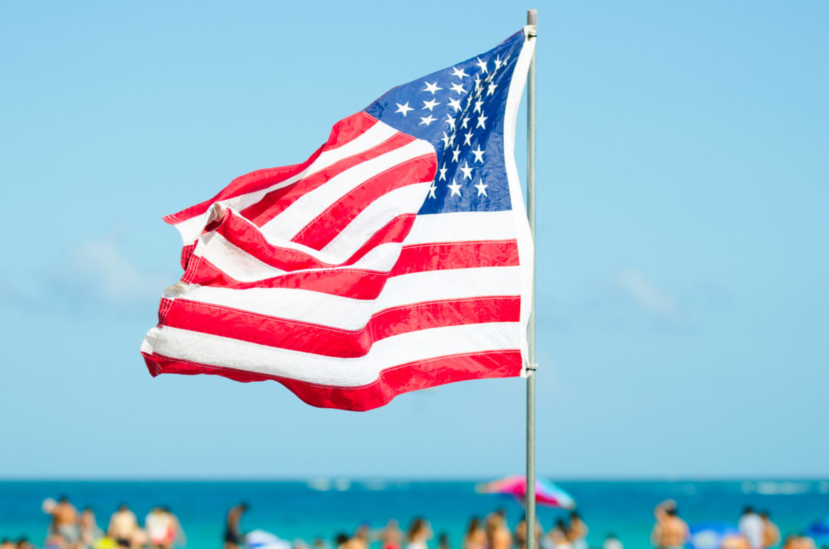 American Flag Flying Over Bright Beach Scene