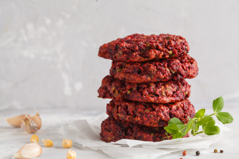 Beetroot vegan burgers with chickpea and herbs. Healthy vegetarian food concept. Copy space, light background.