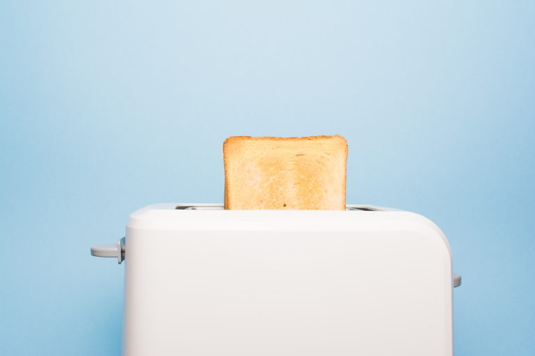 Healthy fashion food of breakfast. Toast in a toaster on a blue background.