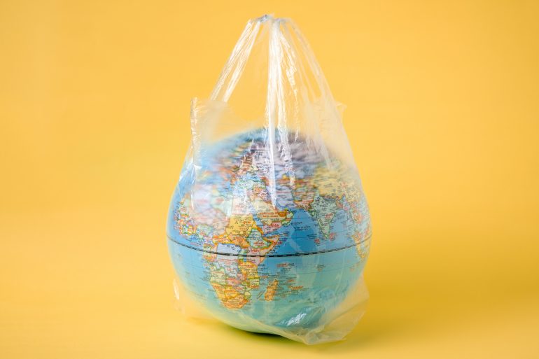 globe model in plastic bag, save the world environment