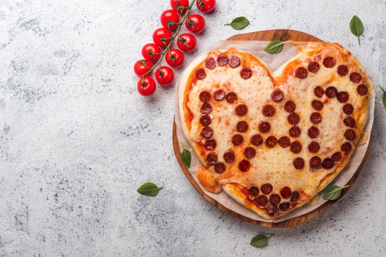Pepperoni pizza in heart shape and dad word