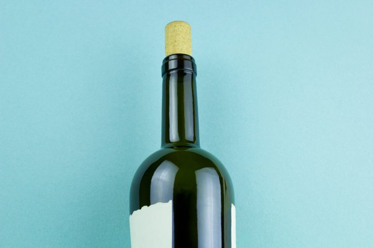 Bottle of wine with white label on blue background